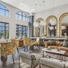 Upscale resident clubhouse with large windows and comfortable seating at The Lacy at South Main Kennesaw apartments