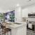 Kitchen with gooseneck faucet and side by side fridge 