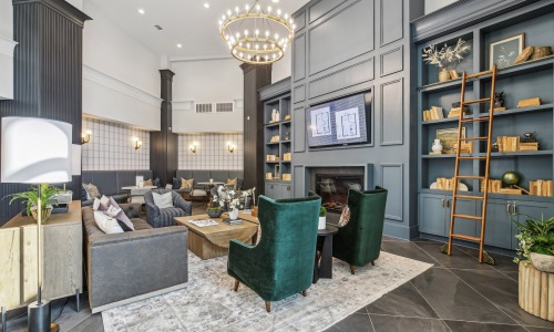 a room with a fireplace and chairs